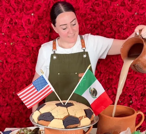 A Panfila baker pouring hot chocolate from a giant barro pitcher beside the football-shaped Conchota